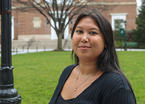 female student with black hair on university quadrangle