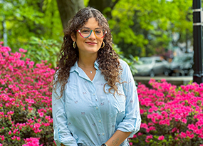 female student with brown hair and glasses