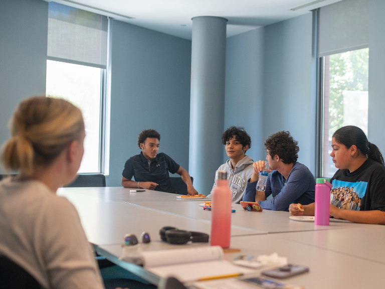 CSTEP students sitting around a table having a discussion