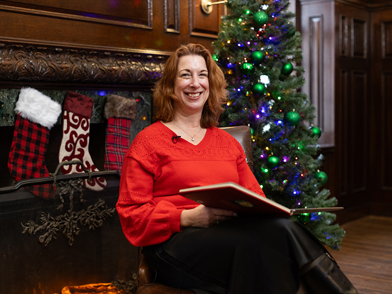 A scene depicting the recording The Night Before Christmas read by Dean Marcy Kelly, Ph.D., of the Kakos School of Arts and Sciences