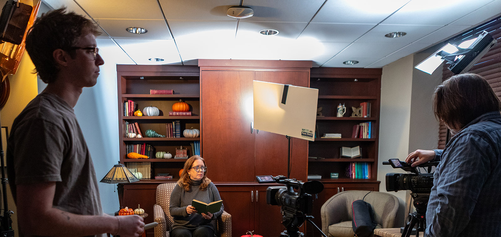 A scene depicting the recording Thanksgiving by Ella Wheeler Wilcox read by Deirdre O’Leary Cunningham, Ph.D., Associate Professor of English.