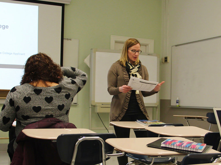 Professor and students participate in a group discussion.