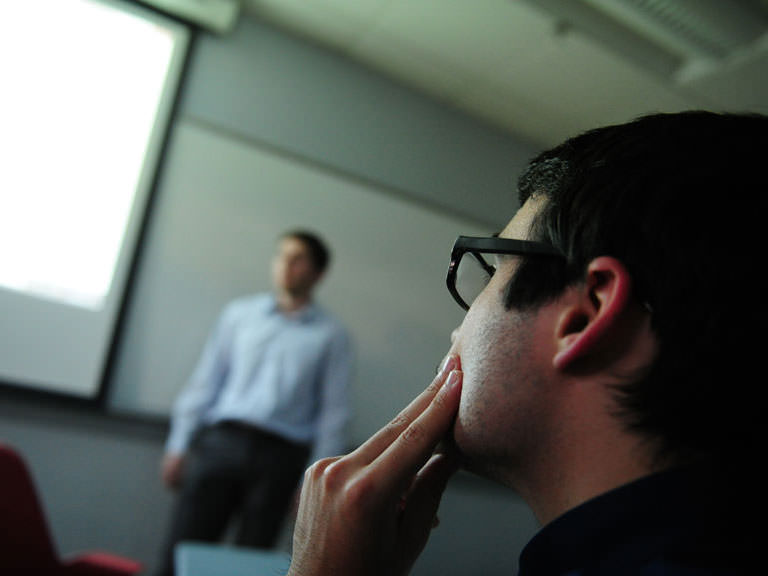 Student watches a film clip as part of a classroom lecture.