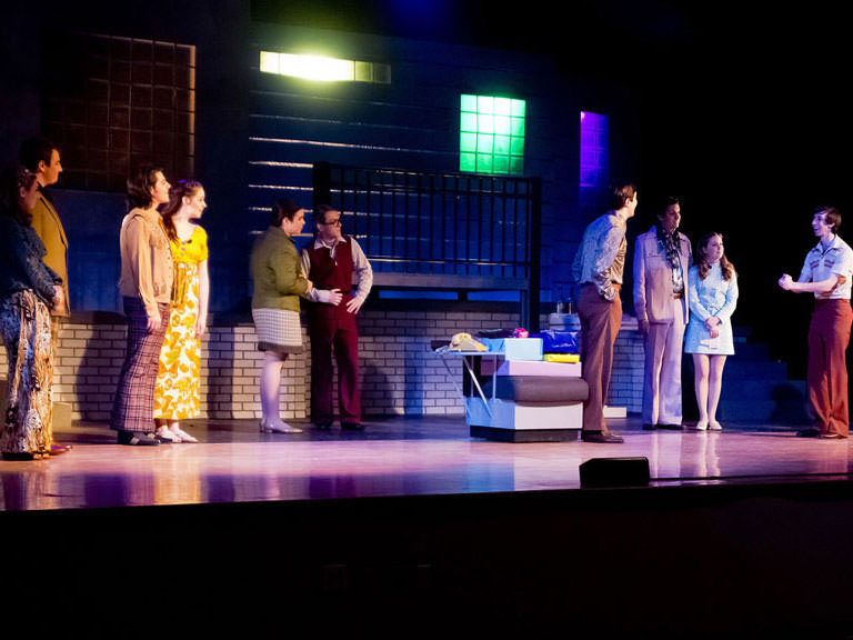 Students perform in a play at the College.