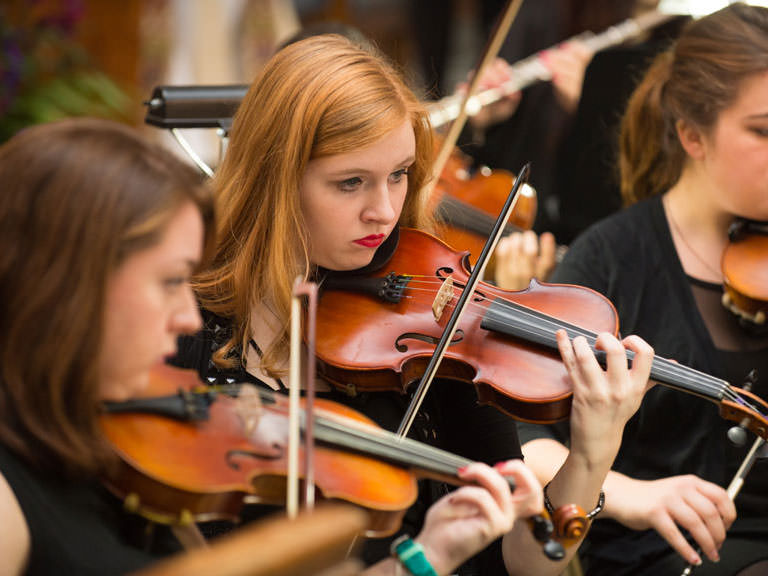 Students play in the orchestra.