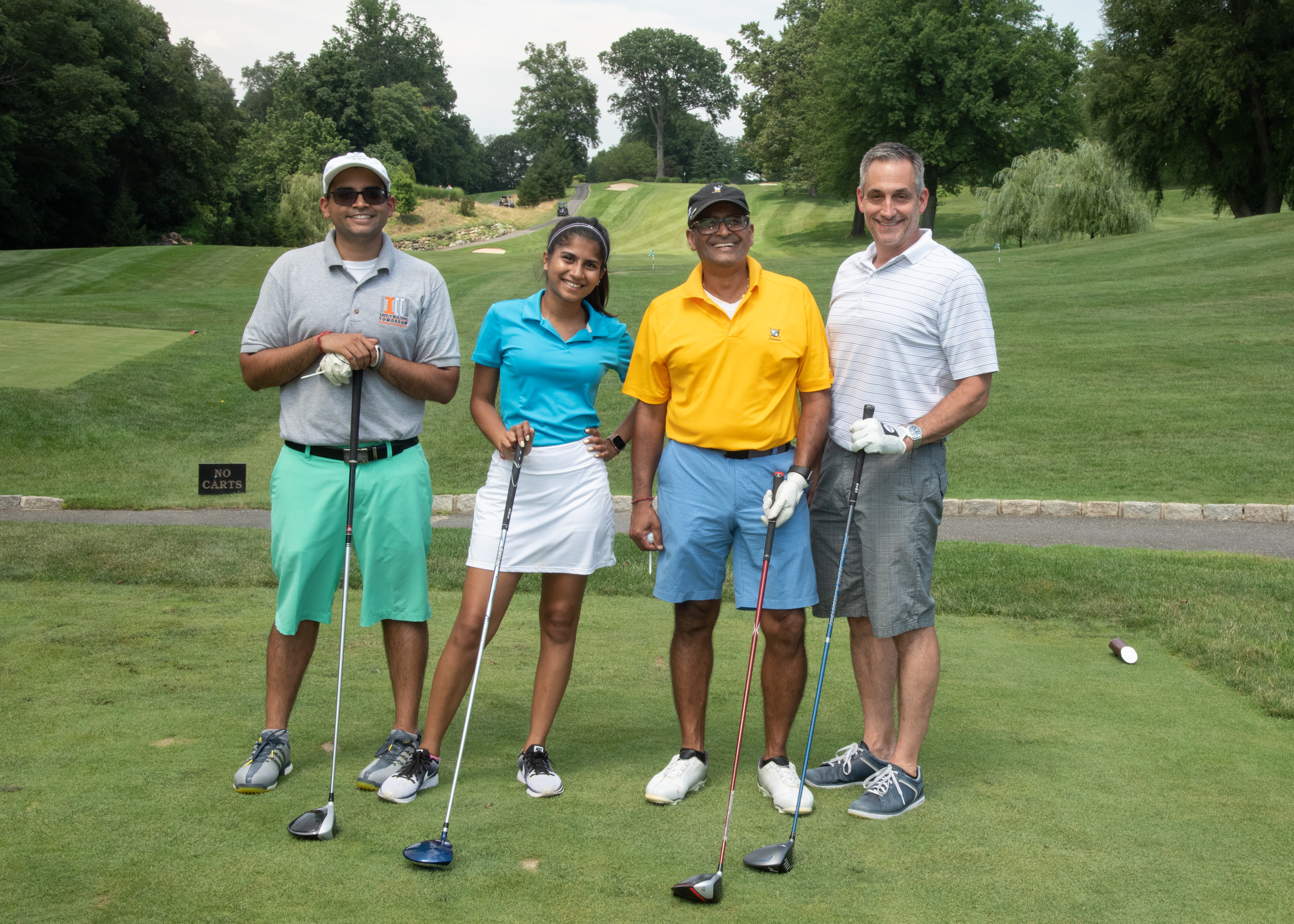 four manhattan college alumni at the 2019 construction golf outing