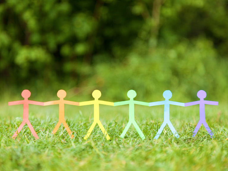 Rainbow-colored stick figures holding hands in acceptance.