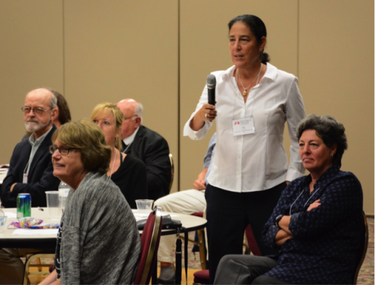 faculty ask a panelist questions at international symposium
