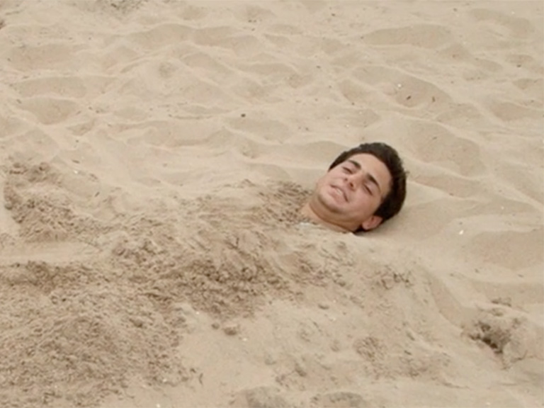 Matt Marcello buried in sand