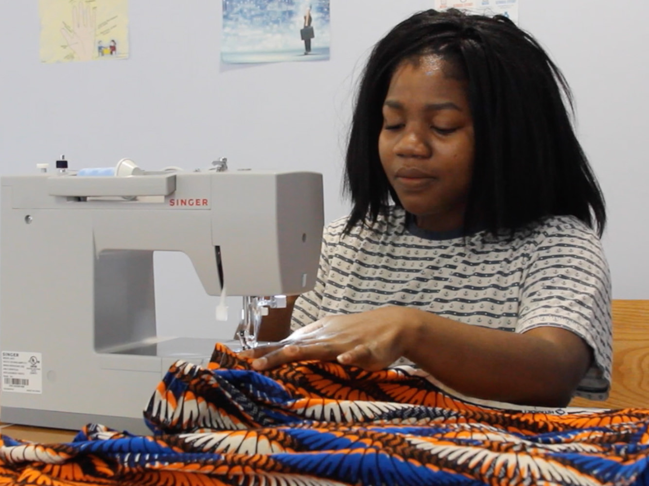 student creates clothing line with sewing machine