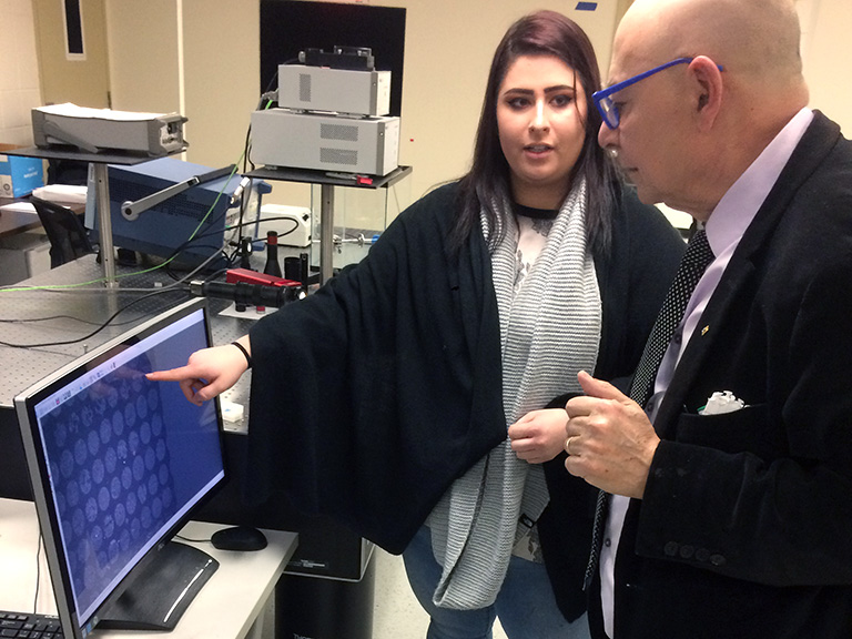 Gloria Bauman, George Giakos working in lab