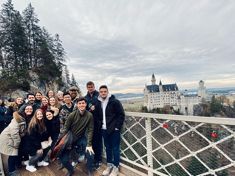 manhattan college students smiling in front of historic building in munich germany