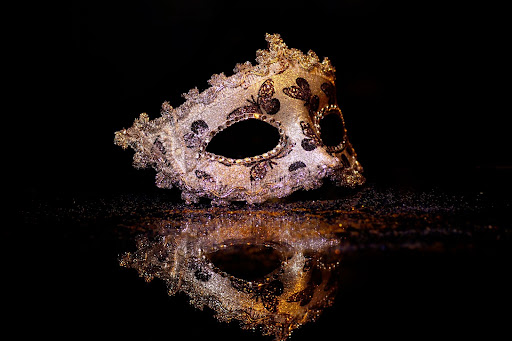 Black ground with image of a masquerade 