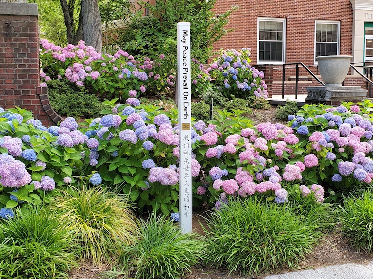 Peace Pole standing outside Smith Auditorium