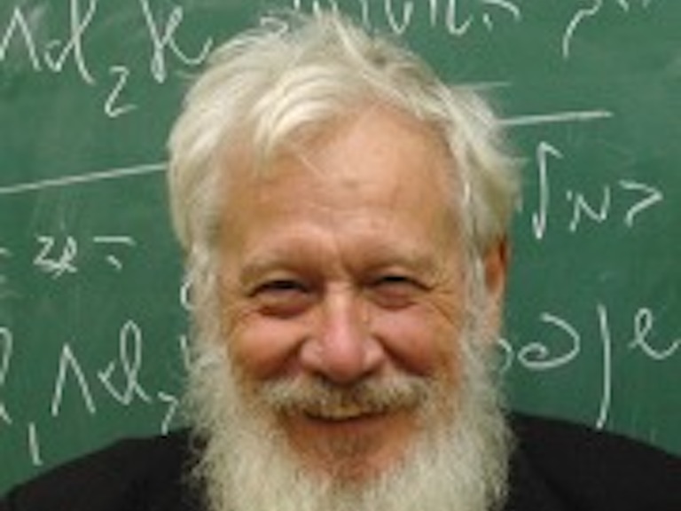 Robert Aumann in front of blackboard