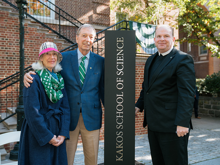 Picture of Michael and Aimee Kakos with Brother Daniel Gardner FSC President of Manhattan College