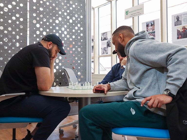 students gathered around table and having a conversation