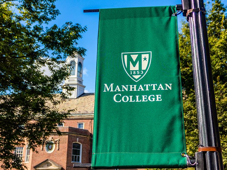 Manhattan College flag on campus in the quad
