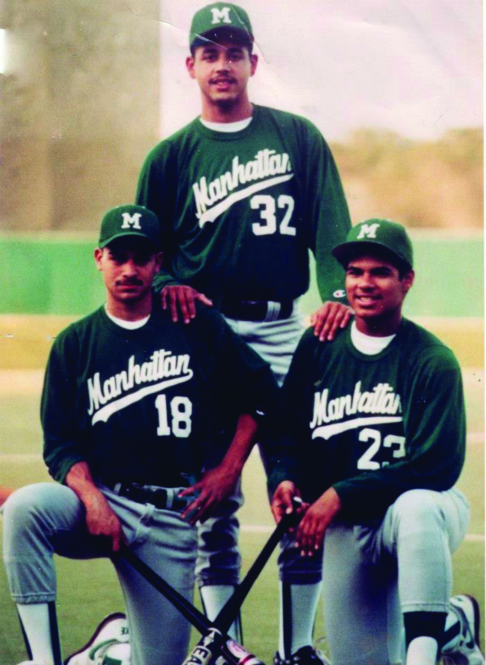 Three Manhattan University baseball players in green uniforms pose on the field during a collegiate season.