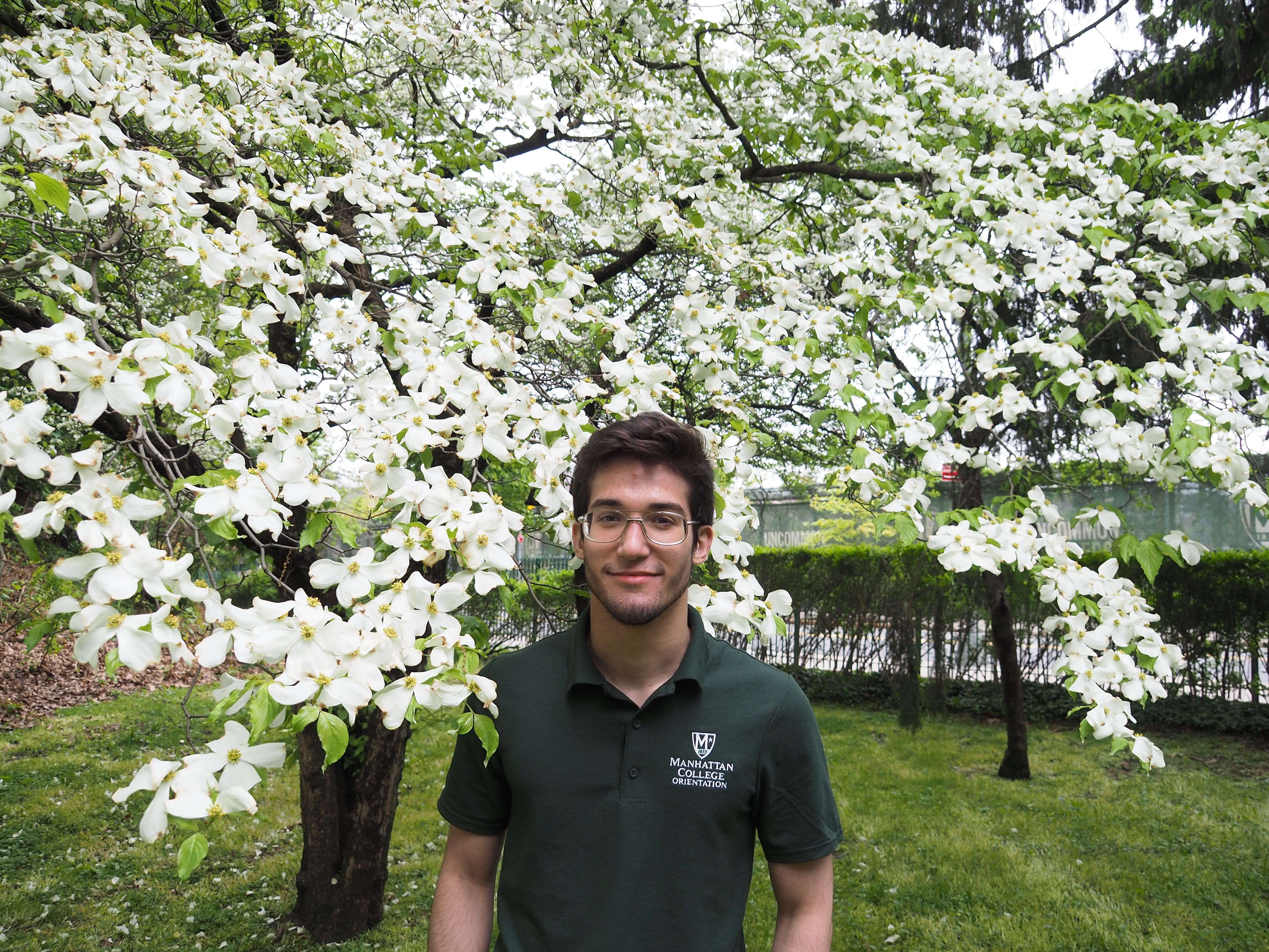 Male student in front of flowers.