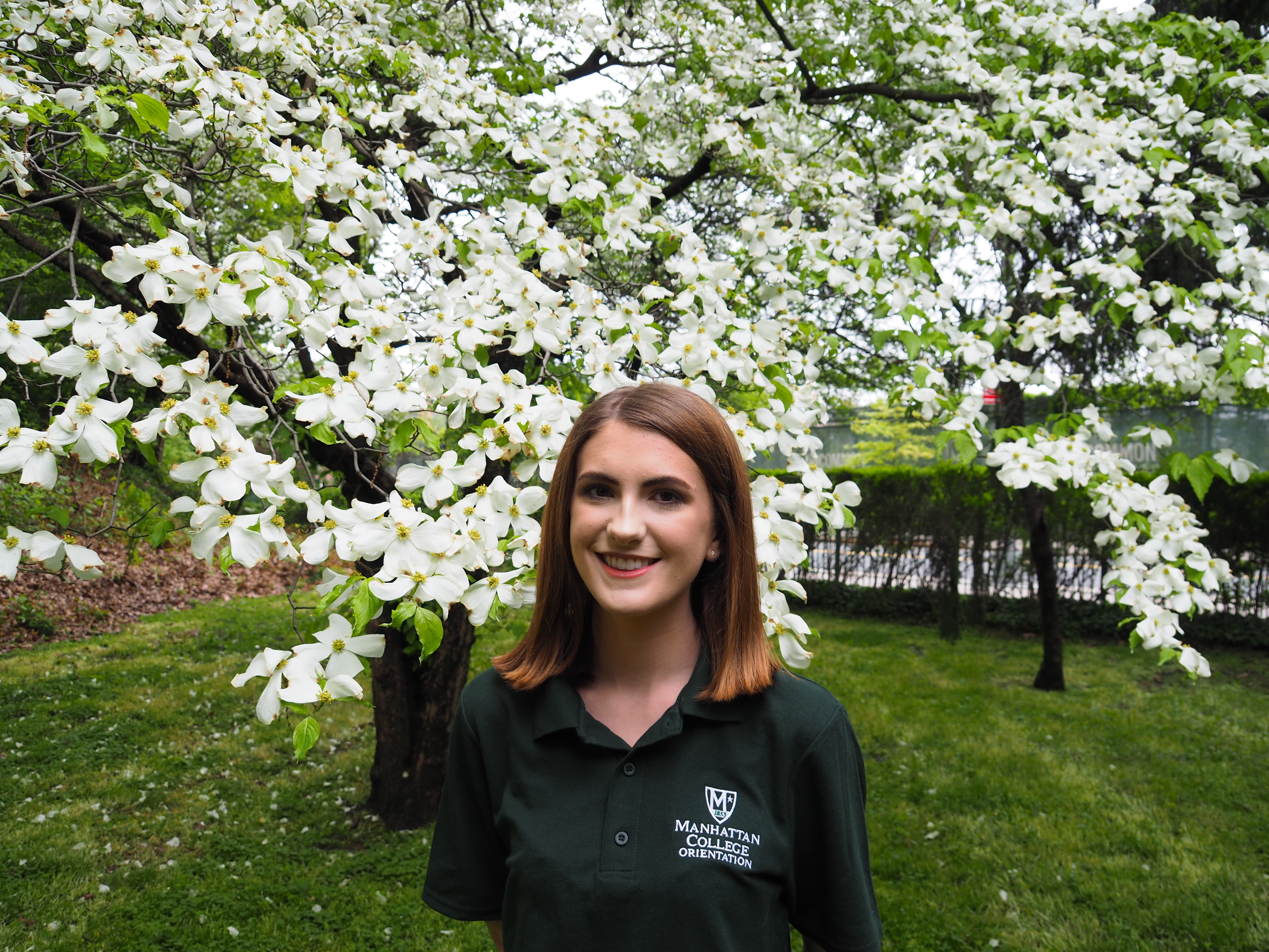 Image of female student in front of flowers.