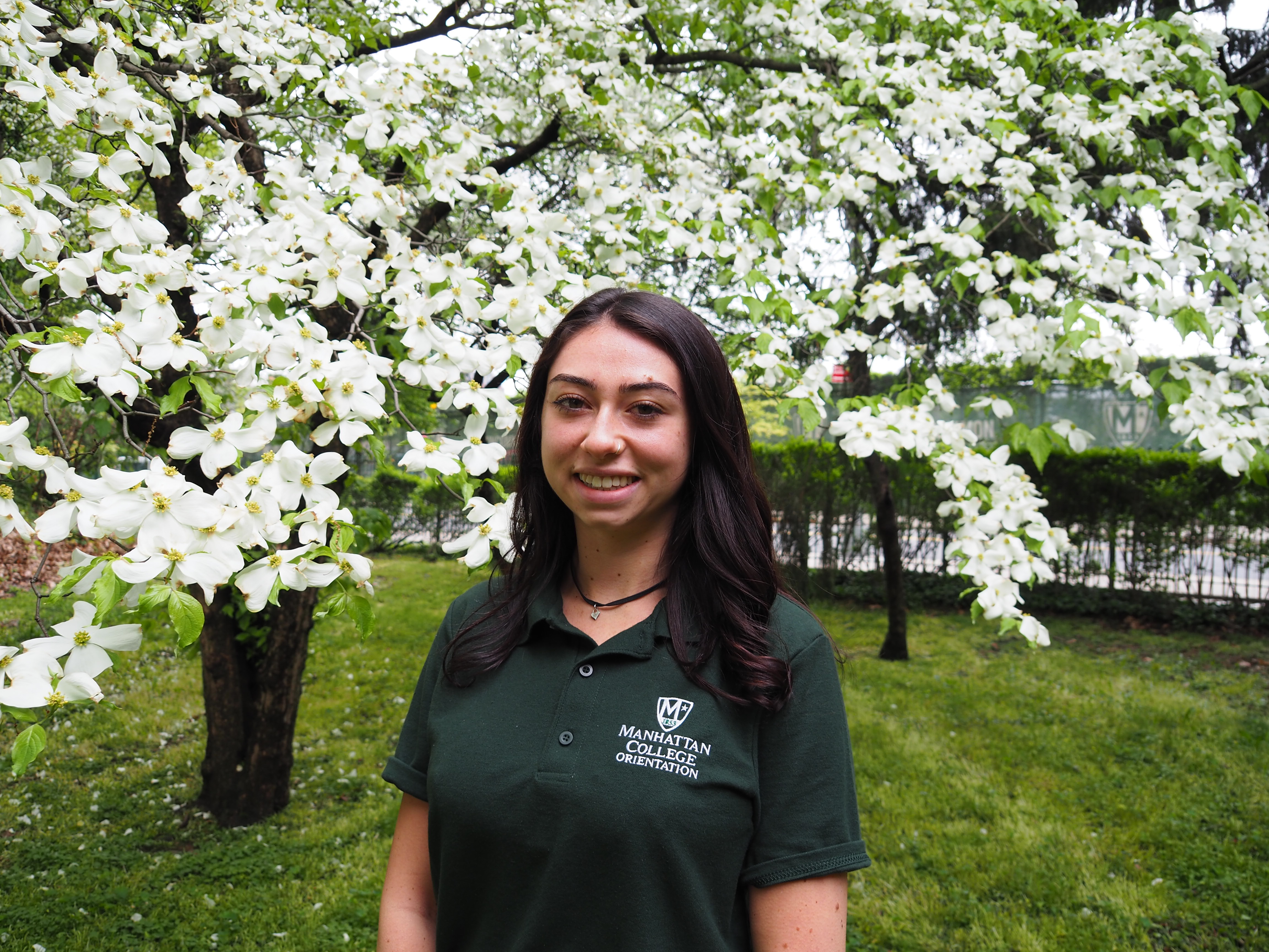 Image of female student in front of flowers.