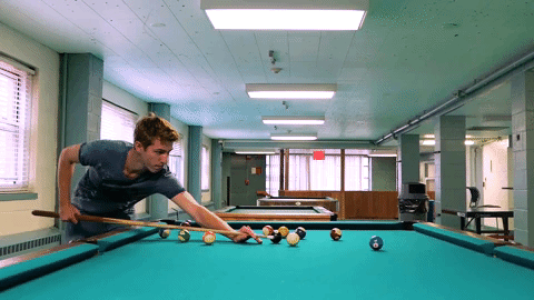 male student playing pool