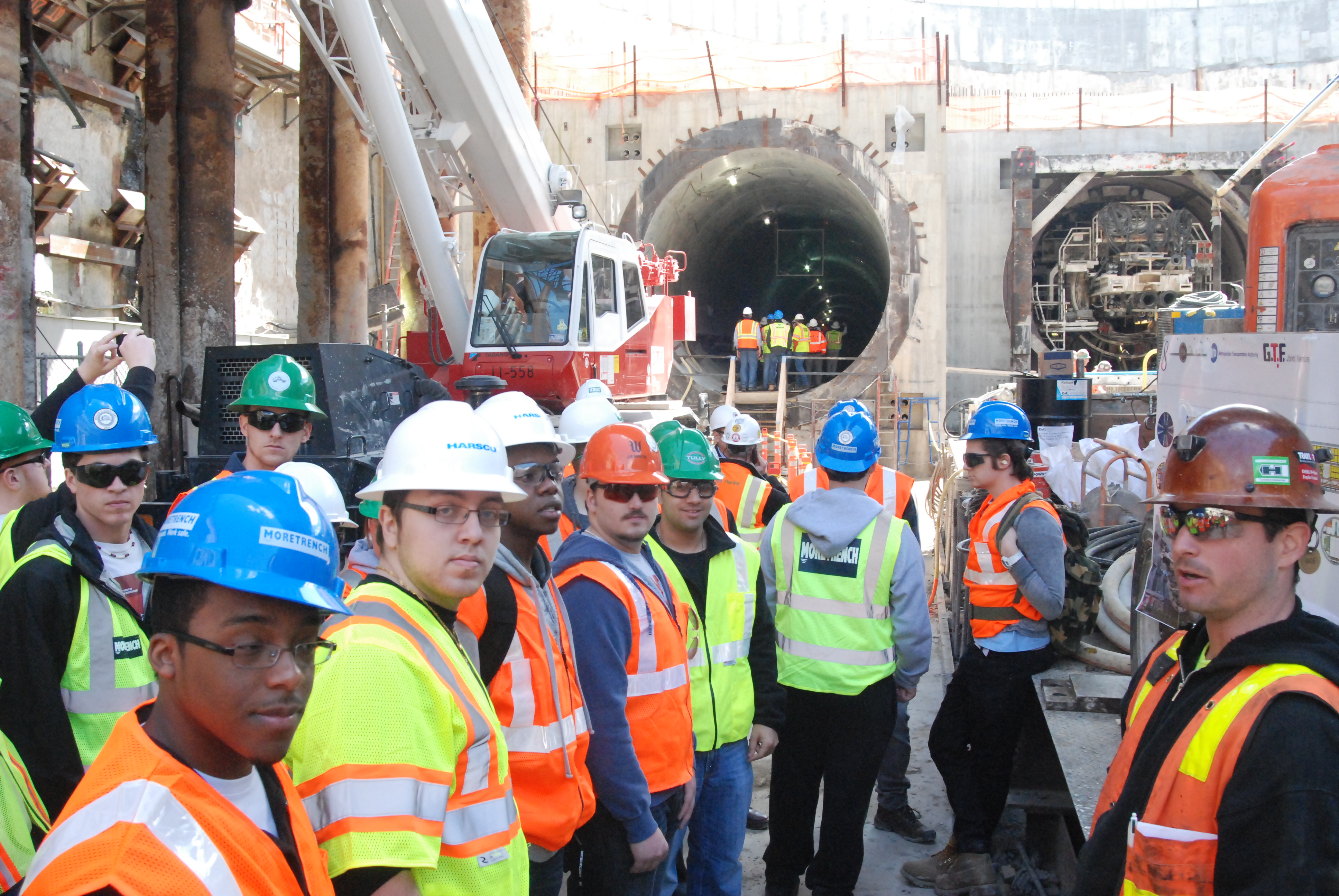 summer engineering students at a job site wearing hard hats