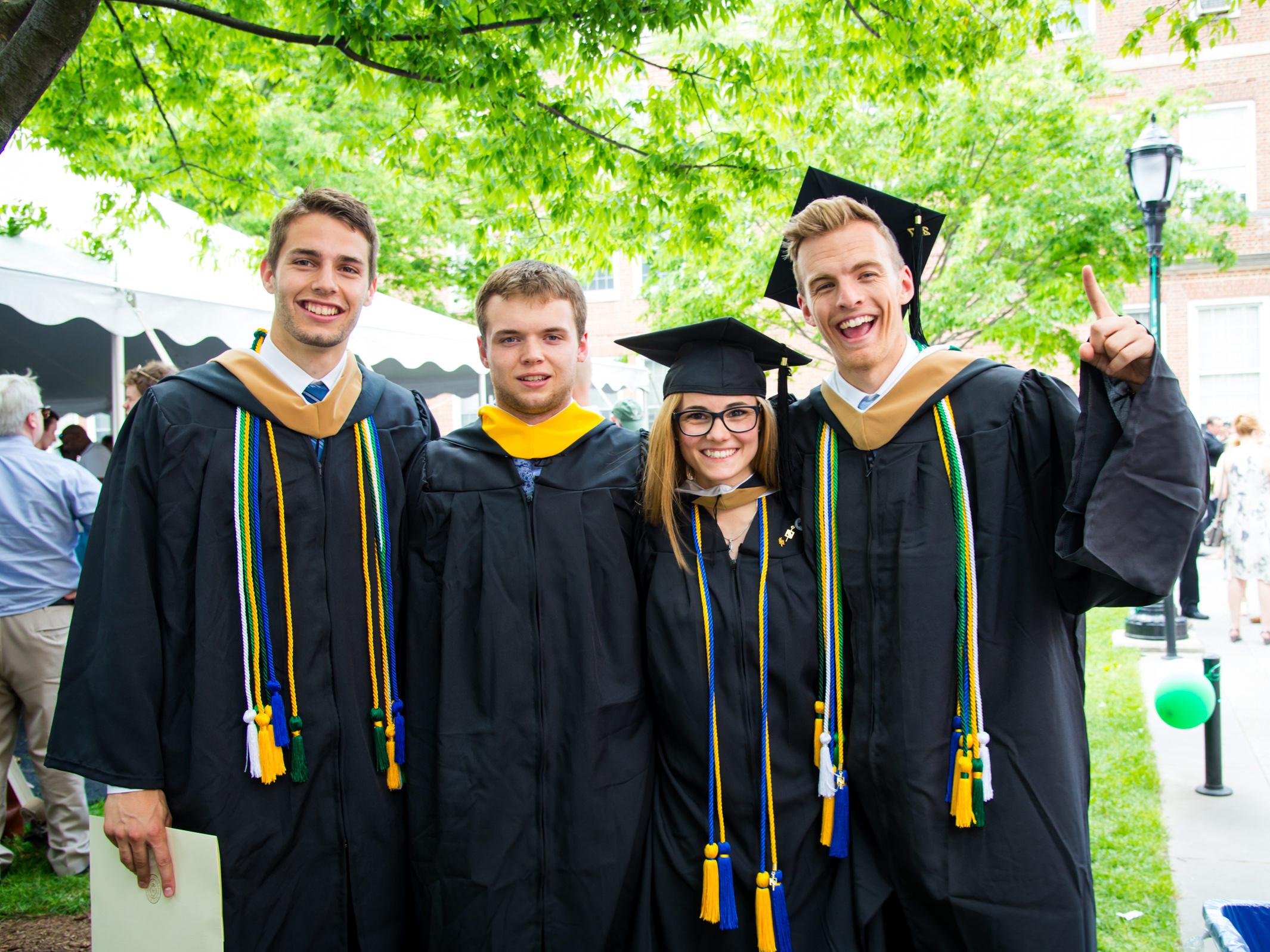 graduating seniors pose for a photo on the quad on graduation day